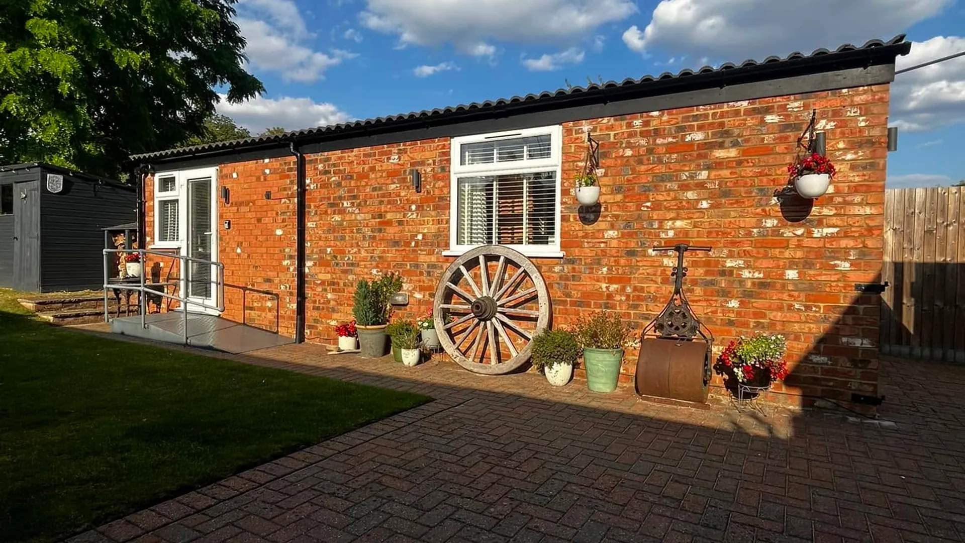 The red brick Ford Lodge garden annexe in sunshine