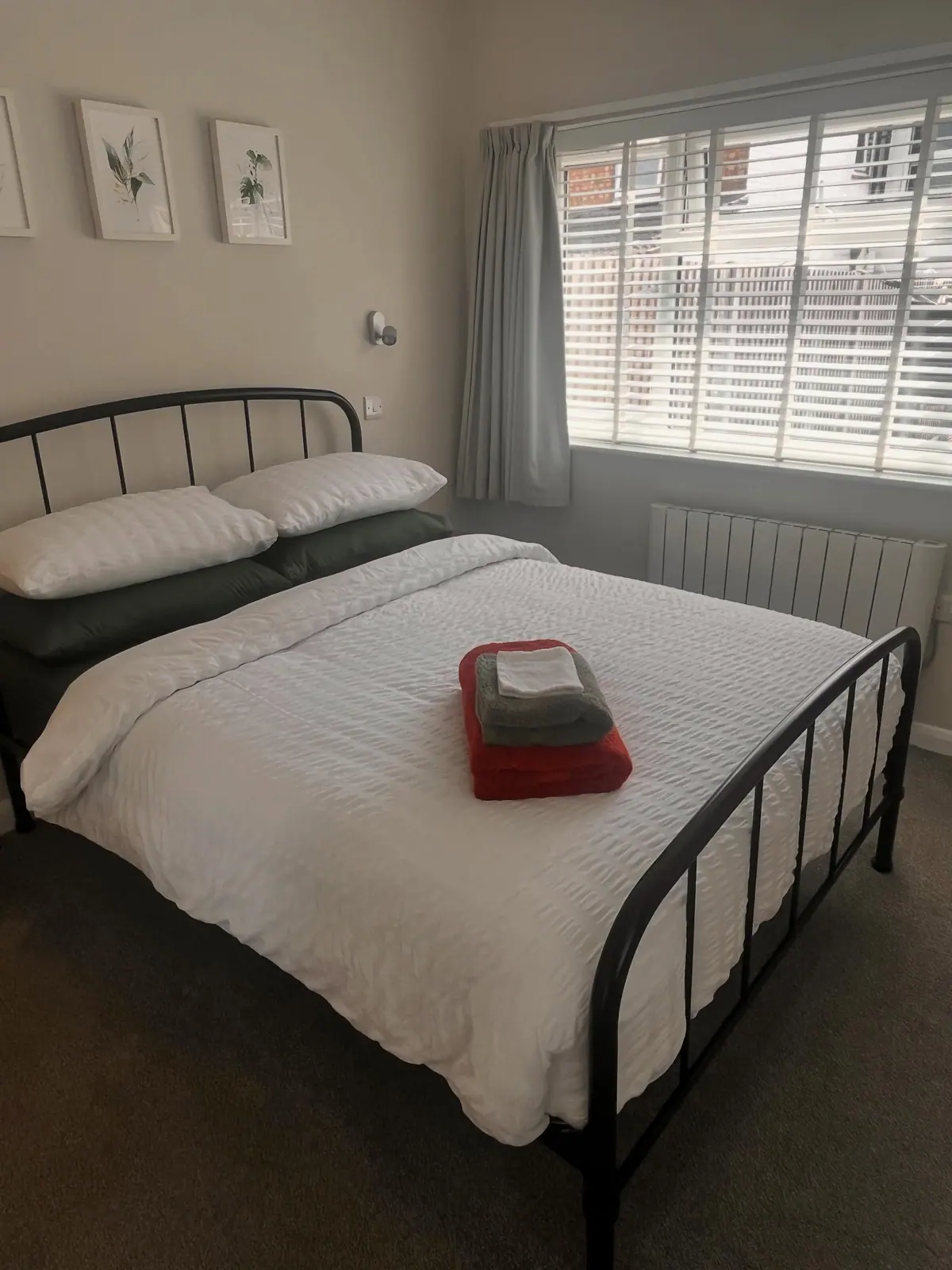 Double bedroom with bedside lights and window shutters